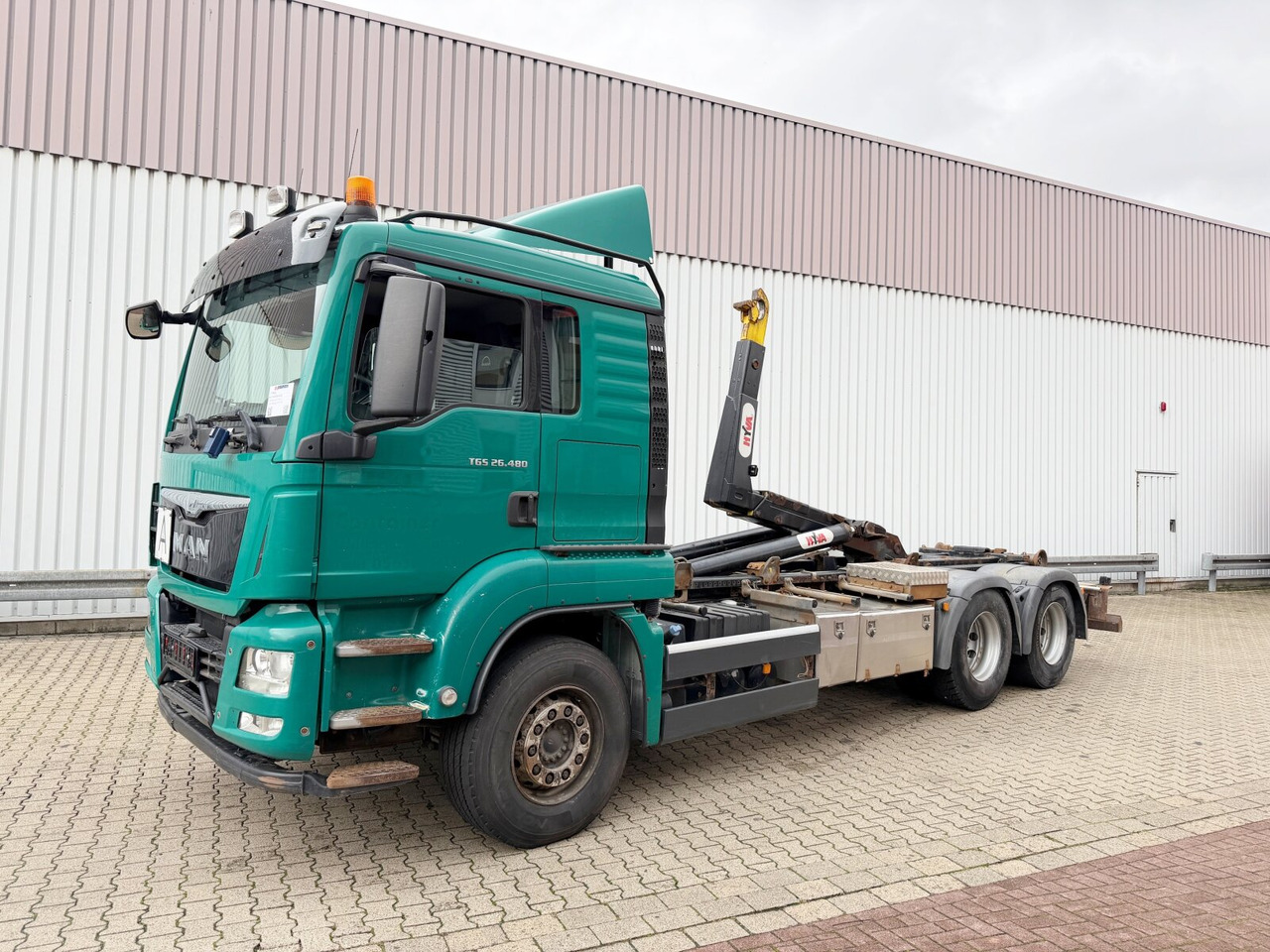 MAN TGS 26.480 6x4 BL TGS 26.480 6x4 BL, Motorabtrieb, Navi, Intarder, Hyva 20.60 S - Camion cu cârlig: Foto 1 MAN TGS 26.480 6x4 BL TGS 26.480 6x4 BL, Motorabtrieb, Navi, Intarder, Hyva 20.60 S - Camion cu cârlig: Foto 1