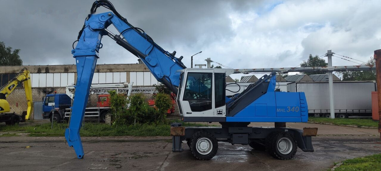 Fuchs MHL 340 D FQC magnet generator - Excavator pentru manipulare de materiale: Foto 1 Fuchs MHL 340 D FQC magnet generator - Excavator pentru manipulare de materiale: Foto 1