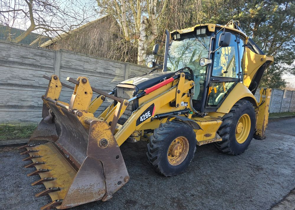 Caterpillar - Buldoexcavator: Foto 1 Caterpillar - Buldoexcavator: Foto 1